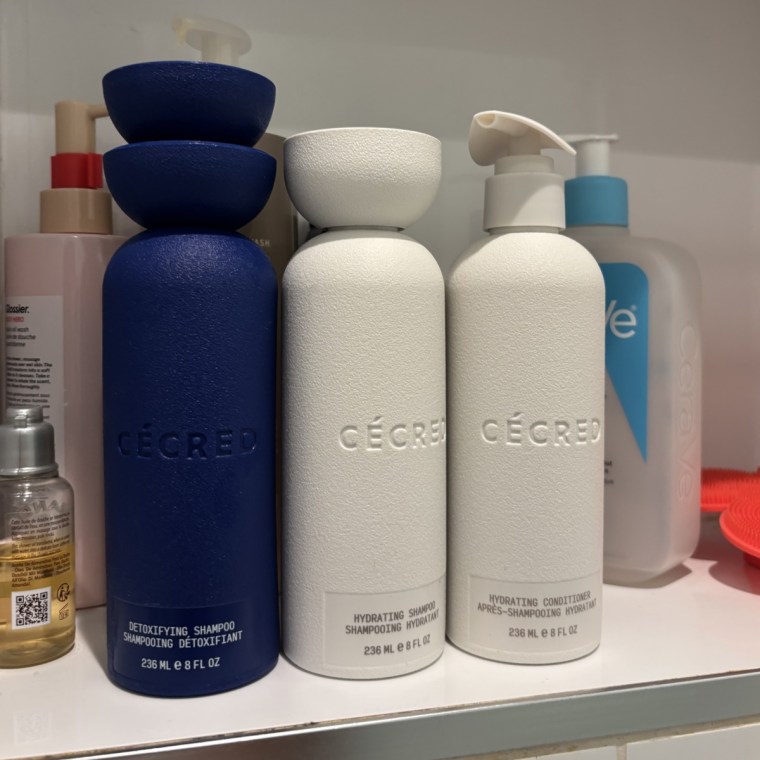 The Cecred Detoxifying Shampoo, Hydrating Shampoo and Hydrating Conditioner lined up on a shower shelf.