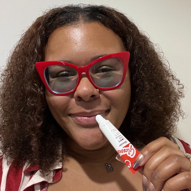 Editor Kamari Stewart-Jackson applies the Glossier I Love NY Balm Dotcom.