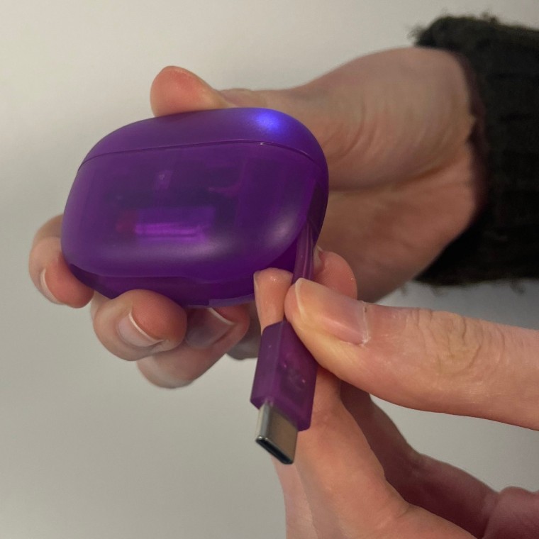 These JLab earbuds have the charging wire built in to the case.