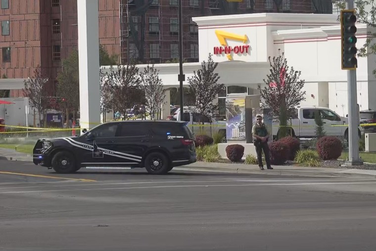 A law enforcement officer stands outside an In-N-Out Burger restaurant in Twin Falls, Idaho, where a shooting was reported Saturday.