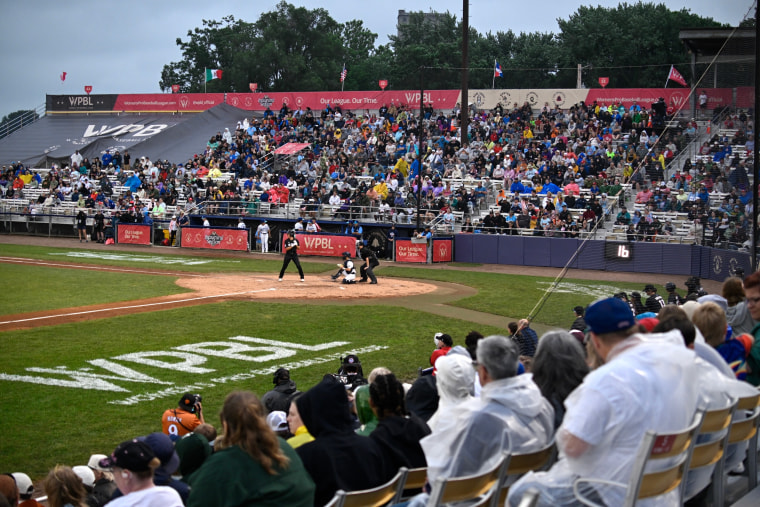 Image: Fans watch the fourth inning of the inaugural Women's Professional Baseball League game between the Los Angeles Queens and the New York Heights.