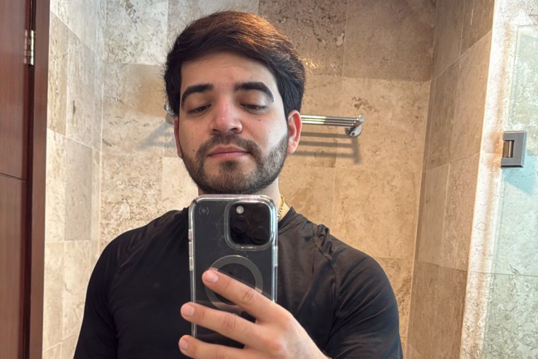 Cesar Gastelum takes a selfie in a bathroom mirror