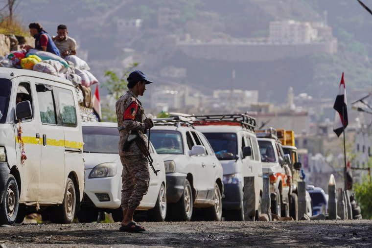 A Houthi fighter stands at a checkpoint in Taiz, Yemen.