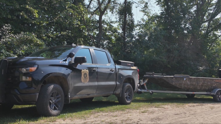 Scene video shows police vehicles near the Muskegon River, in Michigan, where the three tubers went missing.