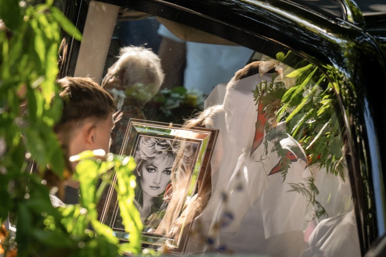 A portrait of Bonnie Tyler seen through the window of a car.