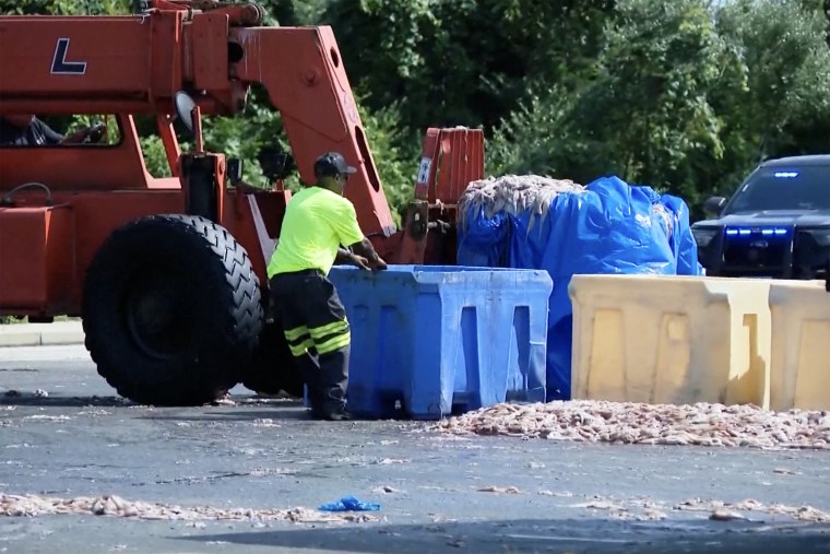 Workers clean up the spill in Narragansett.