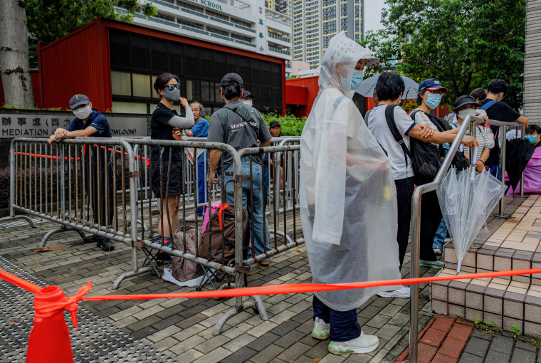 People wait outside the West Kowloon Magistrates' Courts