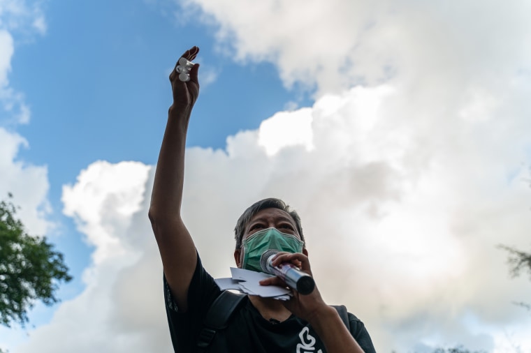 Pro-democracy activist Lee Cheuk-yan holds candles as he speaks