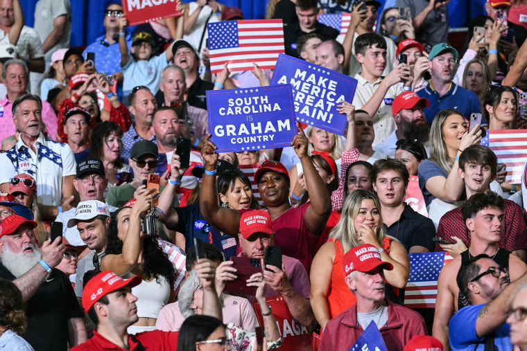 Attendees cheer as U.S. President Donald Trump arrive to rally.