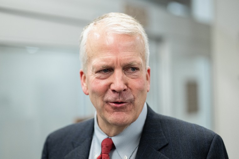 Sen. Dan Sullivan smiles while speaking inside the U.S. Capitol