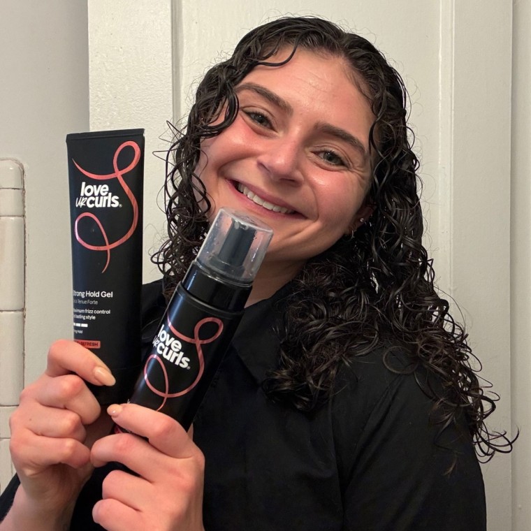 The bottles of Love Ur Curls’ Volumizing Foam and Strong Hold Gel against a white wall.