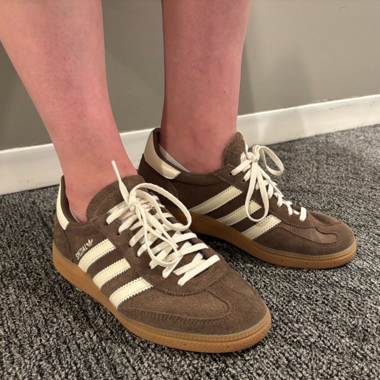 A woman wearing the Adidas Handball Spezial Shoes in the Earth Strata/Off White/Gum color.
