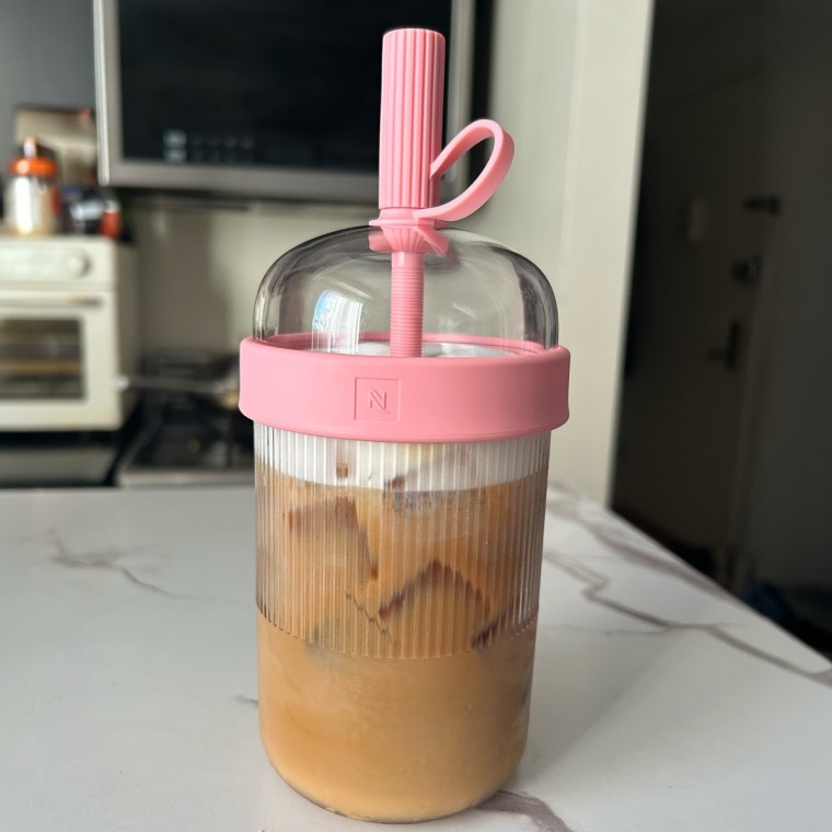 Nespresso Iced Tumbler filled with iced coffee sitting on the kitchen counter.
