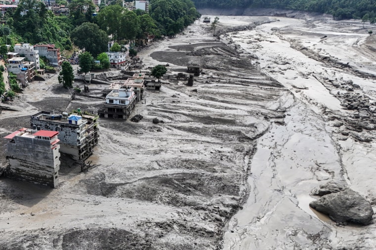 An aerial view shows buildings and infrastructure damaged by floods.