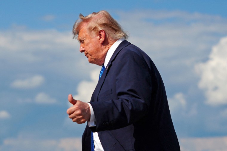 President Donald Trump flashes a thumbs-up while stepping off Air Force One on July 31, 2026. 