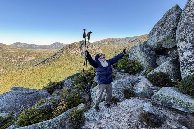 Dale Sanders celebrating after completing a hike.