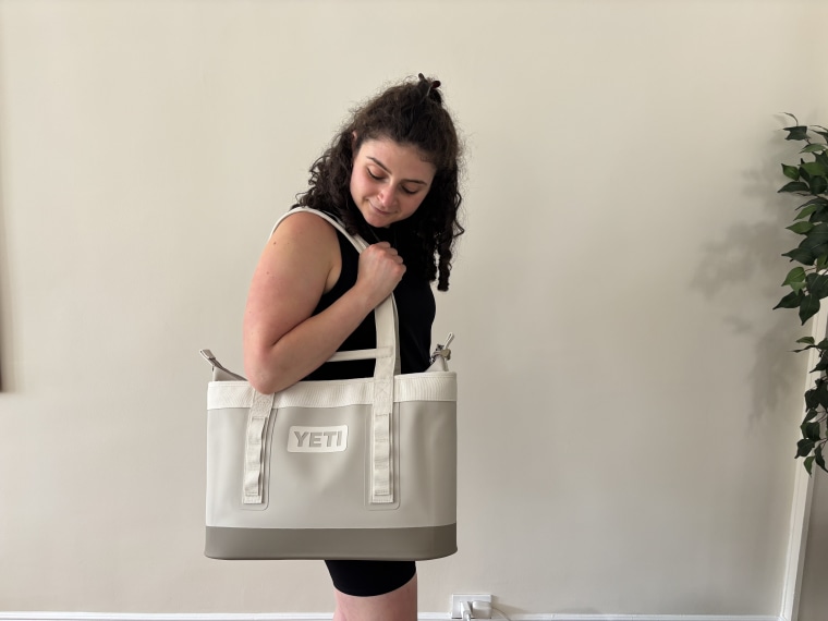 Woman holding a white Yeti Camino.