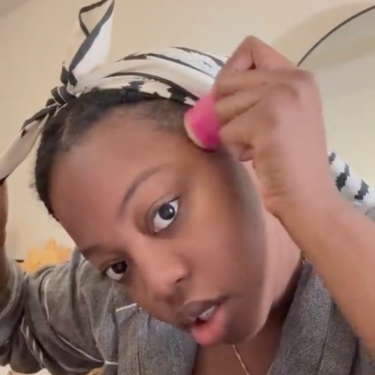 Gif of woman applying wax stick to edges of hair
