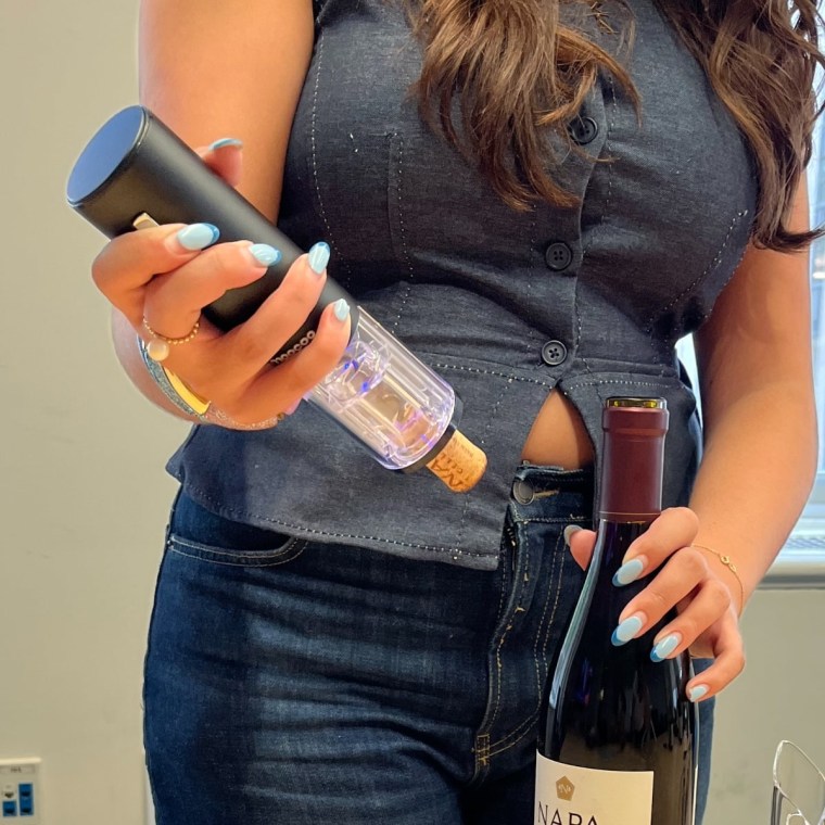 The Moocoo wine electric wine opener has a clear bottom and ejects the cork with the press of a button.