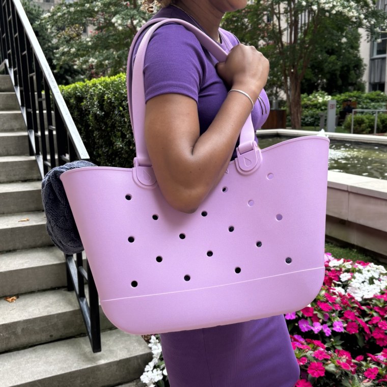 Woman holding pink Simple Modern Getaway tote.