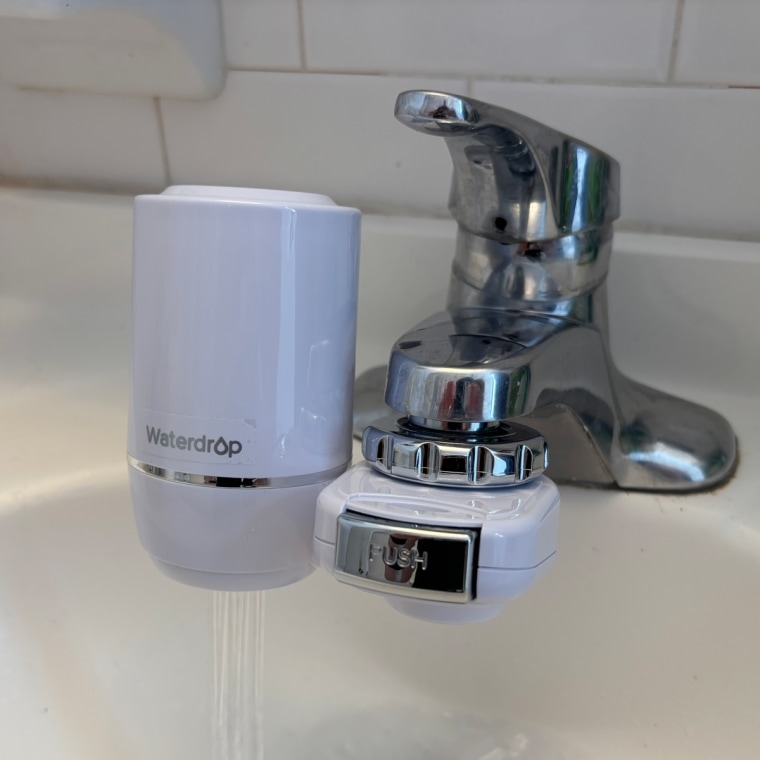 A white Waterdrop Sink installed on a bathroom sink.