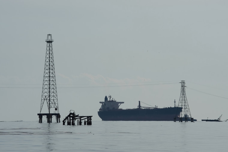 An oil tanker is anchored at sea.