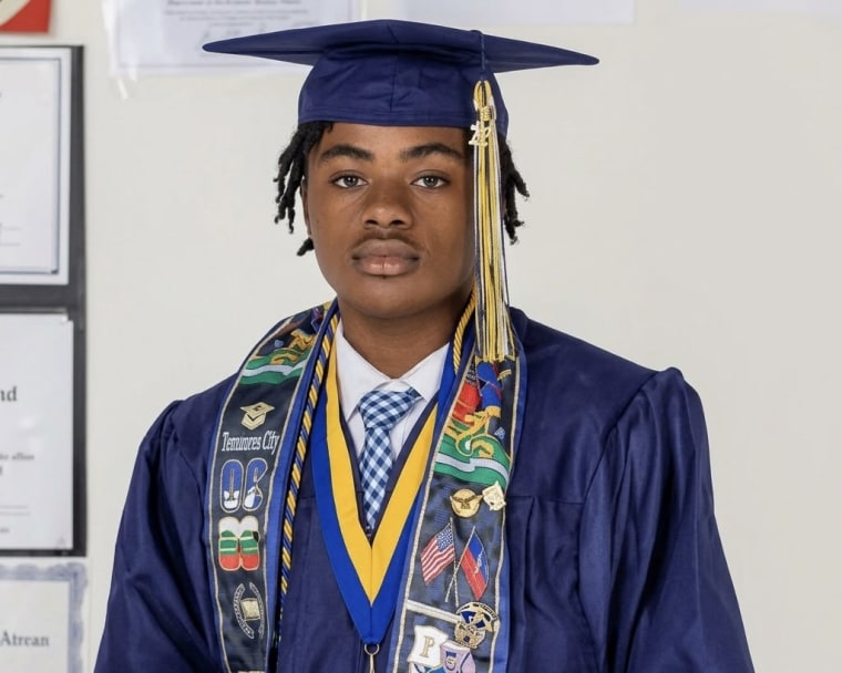 A young man wearing a cap and gown. 