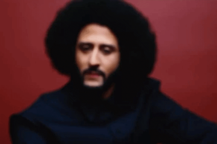 Moving image of Colin Kaepernick, out of focus, turning to look at the camera, in focus.