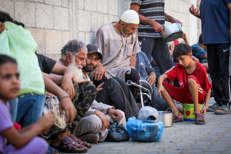 People gather to receive food.