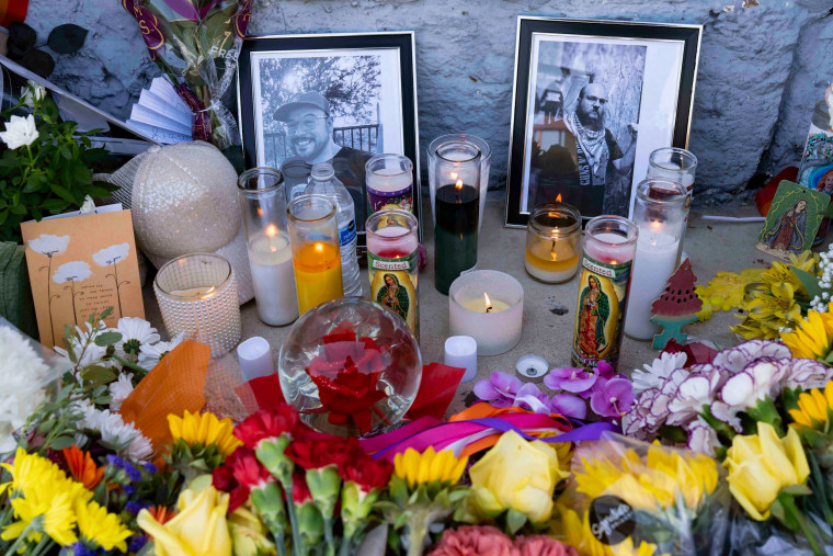 A memorial with two photographs, candles and flowers sits outside Venture-N Bar in Tucson.