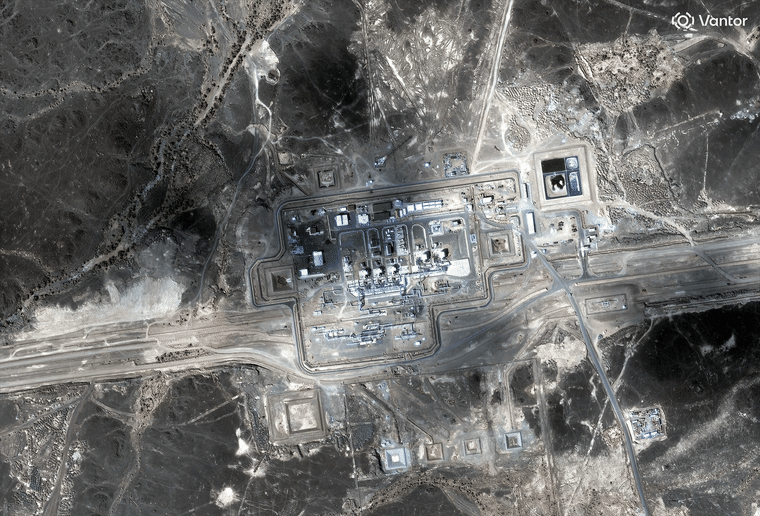 A satellite image of a charred factory complex in the desert.
