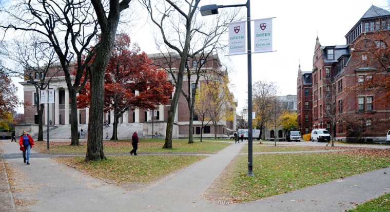 People walk through Harvard Yard at Harvard University, in Cambridge, Mass.