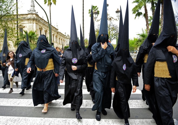 Penitents walk to their church during Holy Week in Seville in southern Spain on April 3. Christians around the world mark the Holy Week of Easter in celebration of the crucifixion and resurrection of Jesus Christ.
