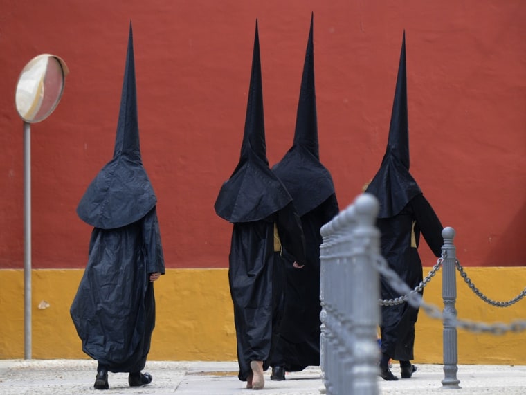 During the Holy Week in Seville, Spain, penitents are pictured walking to their church on April 3. Christians around the world mark the Holy Week of Easter in celebration of the crucifixion and resurrection of Jesus Christ.