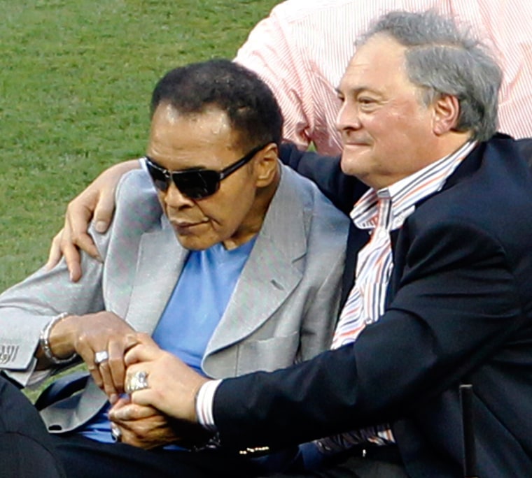 Muhammad Ali, left, rides onto the field with Miami Marlins owner Jeffrey Loria during Opening Day events.