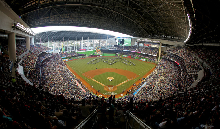 A marching band takes the field at Marlins Park on Opening Day.
