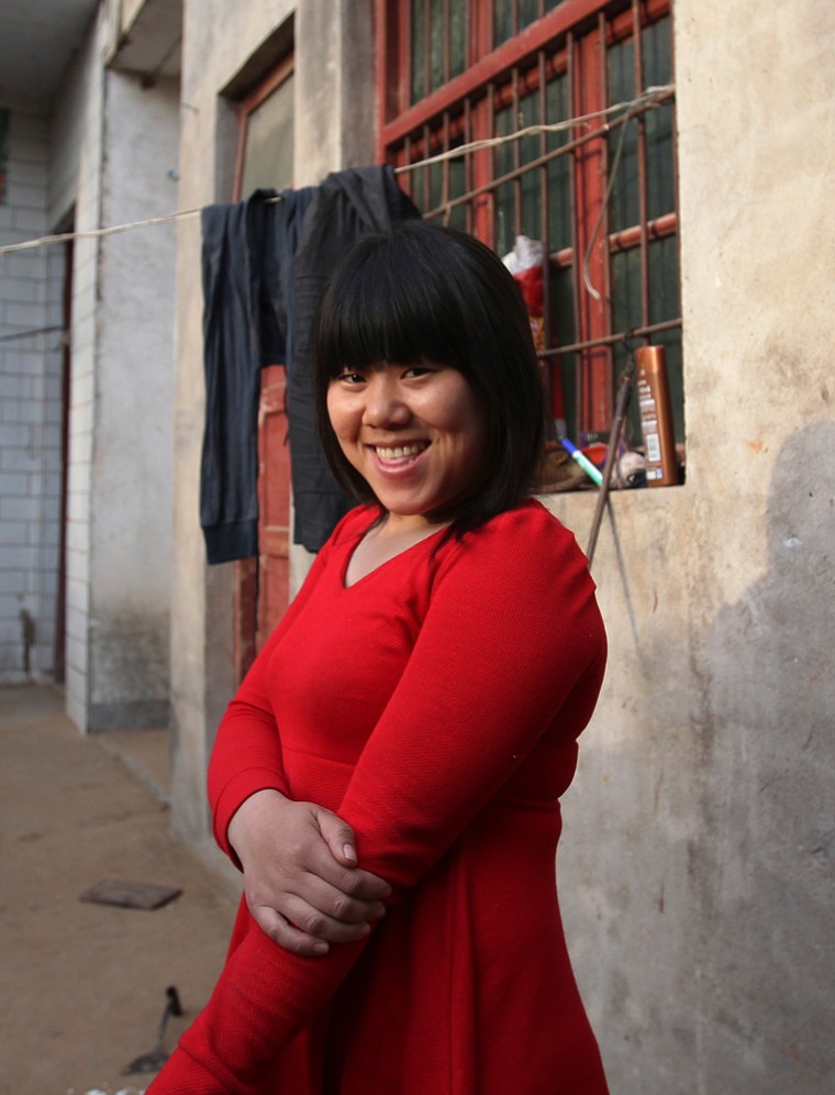 In eight years, Zhang Shuxiang -- seen posing for a photograph at her home in Zhengzhou, China, on Wednesday -- has worked in 20 factories. She wants the Foxconn plant to be her last.