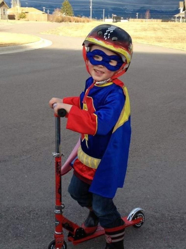 Tayton, 4, kept his super hero status while going on a ride around the neighborhood.
