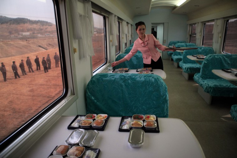 A North Korean waitress serves packaged meals for lunch on a train heading to North Phyongan Province, 35 miles south of the border town of Sinuiju along North Korea's west coast, April 8. North Korean officials escorted a group of international media by train from Pyongyang to see the country's Unha-3 rocket, slated for liftoff between April 12-16, at Sohae Satellite Station in Tongchang-ri, North Korea.