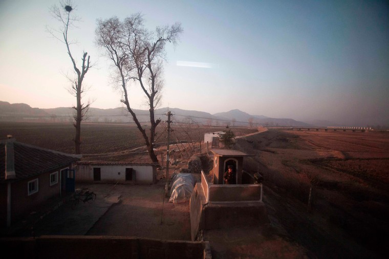 A North Korean soldier stands at a check point seen from a train heading to North Phyongan Province.