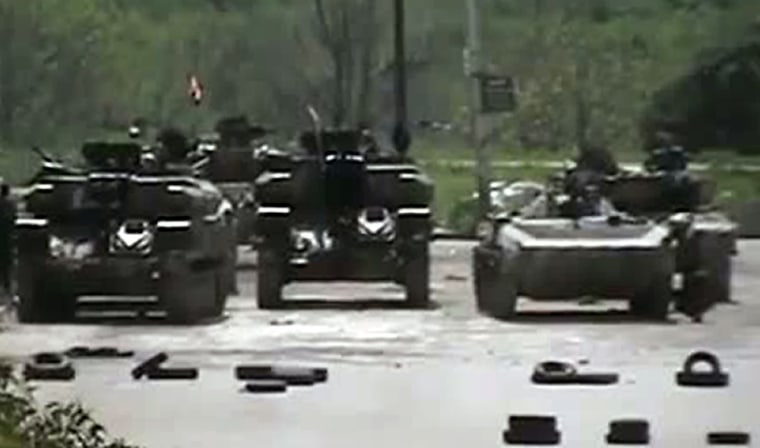 An image grab taken from a video uploaded on YouTube on April 9, 2012 shows Syrian army tanks stationed in the Qusur district of the flashpoint city of Homs.
