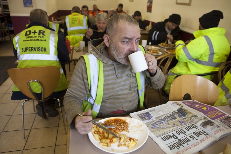 Construction workers take a break from their task of building the Olympic site to enjoy a substantial lunch at The Griddler, a local cafe very close to site of the games.