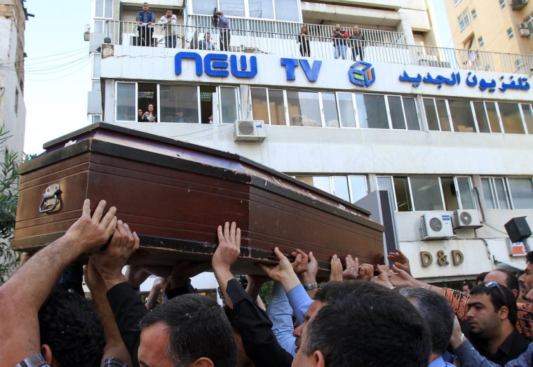 Colleagues carry the coffin of Ali Shaaban outside his TV station's studios in Beirut on April 10, 2012 ahead of his funeral in his hometown Mayfadun, in southern Lebanon.