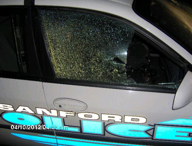 Sanford police say their marked patrol car was shot at several times while parked outside a Florida elementary school, near the gated community where Trayvon Martin was shot and killed.