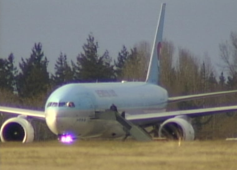 A Korean Airlines Boeing 777 sits on the tarmac of Comox Airport after being diverted from Vancouver International Airport due to a bomb threat.