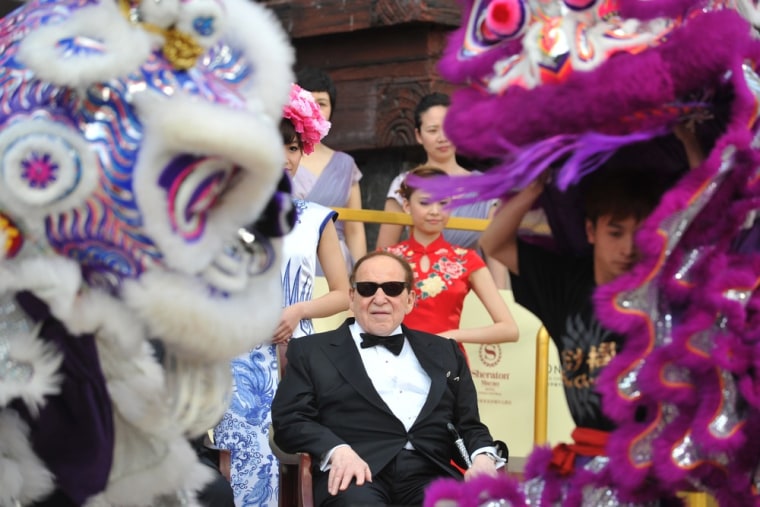 Sheldon Adelson, center, watches a lion dance at the opening ceremony of the Sands Cotai Central in Macau on Thursday.