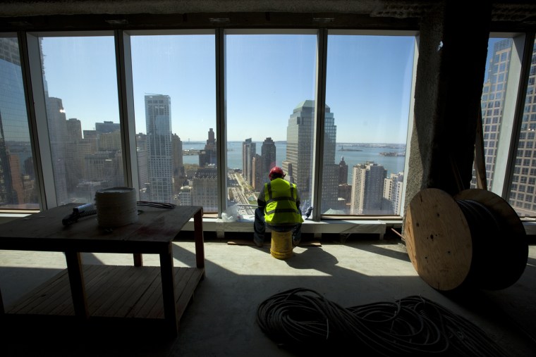 One World Trade Center electrician Victor Rosario takes his lunch break at a window on the 35th floor overlooking the 9/11 Memorial.