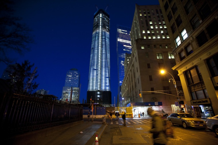 One World Trade Center is illumated in the early morning hours as the building reaches 100 stories and rose higher than the Empire State Building.