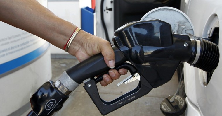 Maria Harris fills her vehicle with gas at a Chevron filling station Monday, March 26, 2012, in Richardson, Texas. Gasoline has already reached $3.90 per gallon, less than a dime from last year's May high. (AP Photo/Tony Gutierrez)