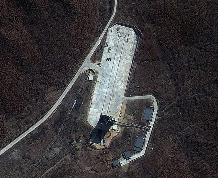 This picture from DigitalGlobe's QuickBird satellite shows the launch pad at the Tongchang-ri Launch Facility in North Korea, as seen on April 9. Three dark-colored support vehicles are lined up on the launch apron. The rail-mounted mobile launch platform is toward the bottom of the pad, with an exhaust deflector that's designed to deal with the hot blast of launch.